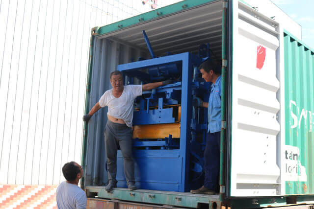 Loading QT4-24 block machine into container for shippment